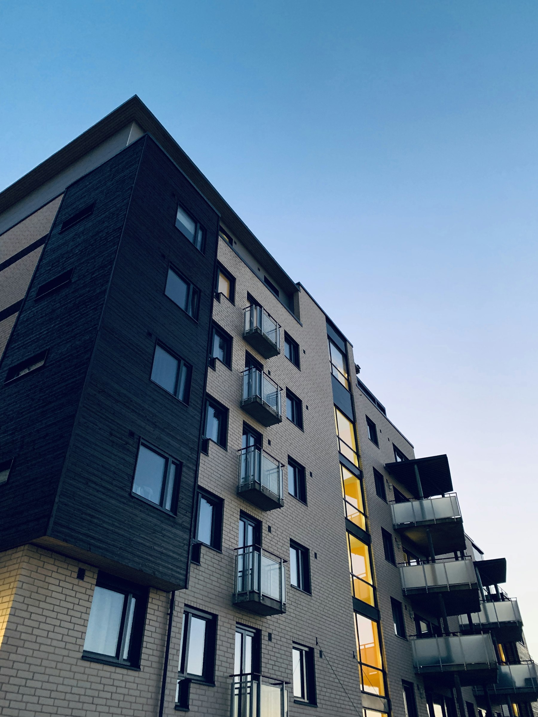 Illustrative multi-storey apartment building at dusk